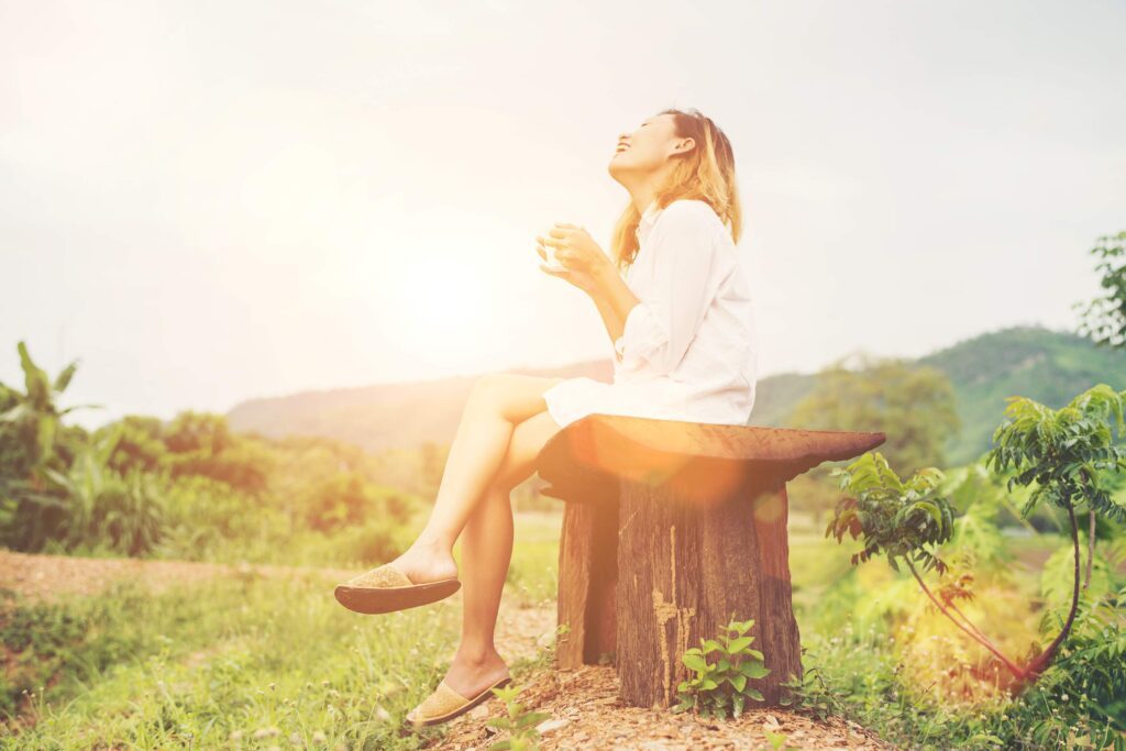 Woman enjoying coffee in nature.