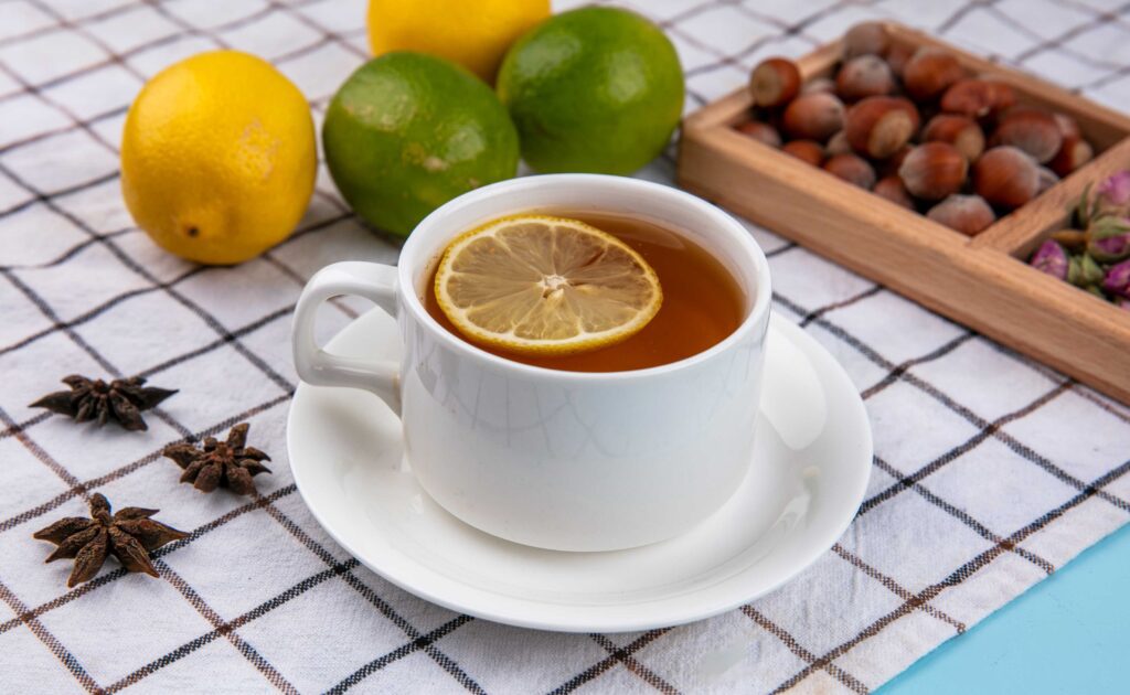 Cup of green tea with lemon slice for metabolism and fat burning