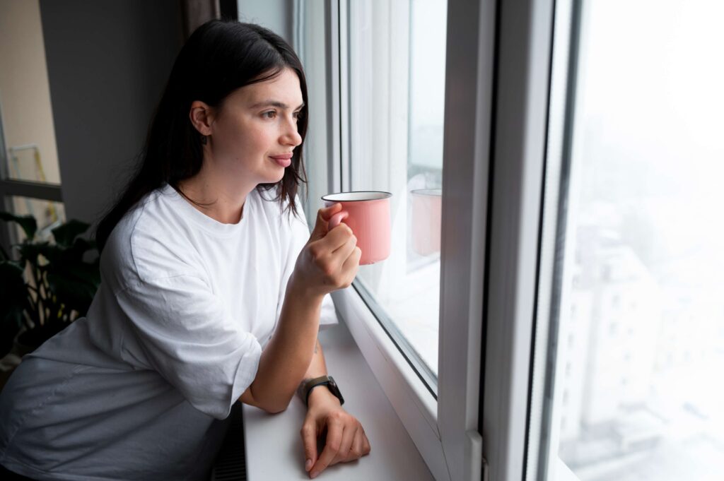Woman closing her eyes and taking a short pause to reduce stress during a busy day