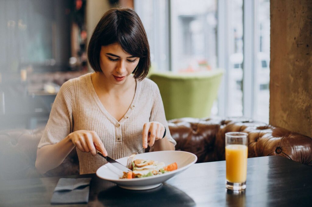 Woman enjoying a slow, peaceful meal to support better digestion and wellness