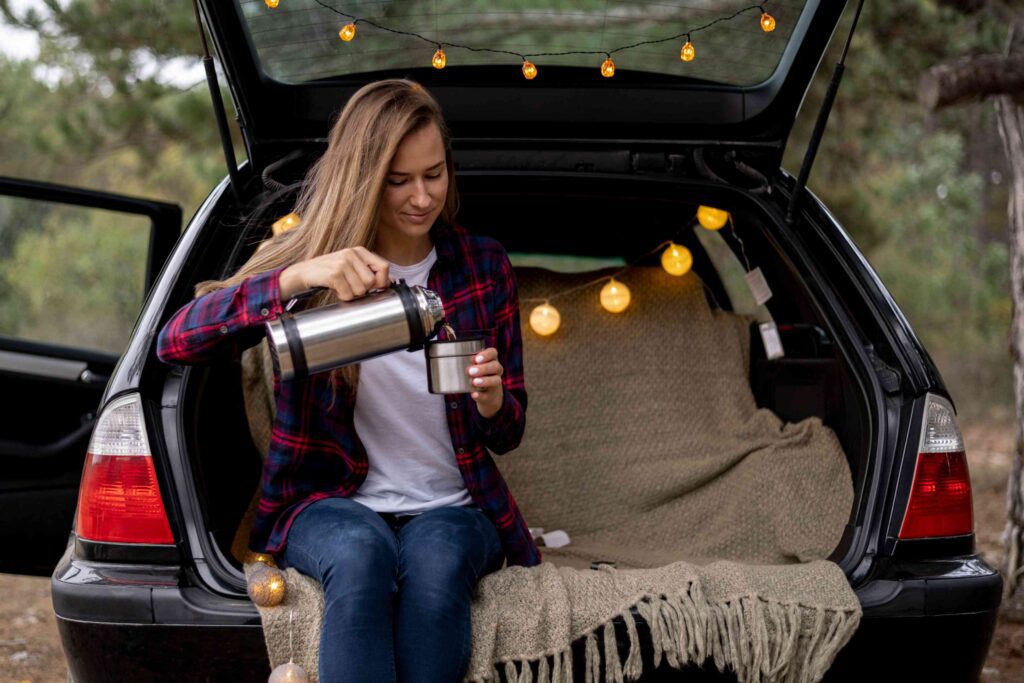Woman enjoying coffee in car.